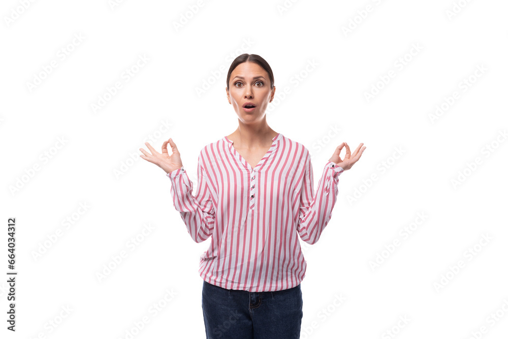 portrait of a slender surprised young brunette office worker woman dressed in a shirt with stripes portrait of a slender surprised young brunette office worker woman dressed in a shirt with stripes
