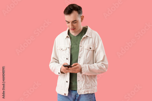 Young man with mobile phone...