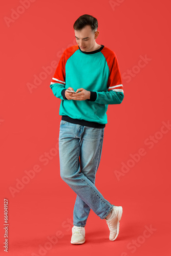 Young man with mobile phone...
