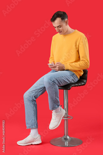 Young man with mobile phone...