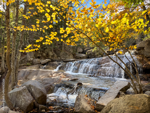 Diana's baths waterfalls - Popular trail by falls along Lucy Brook in Bartlett, New Hampshire showing sunny autumn colors photo