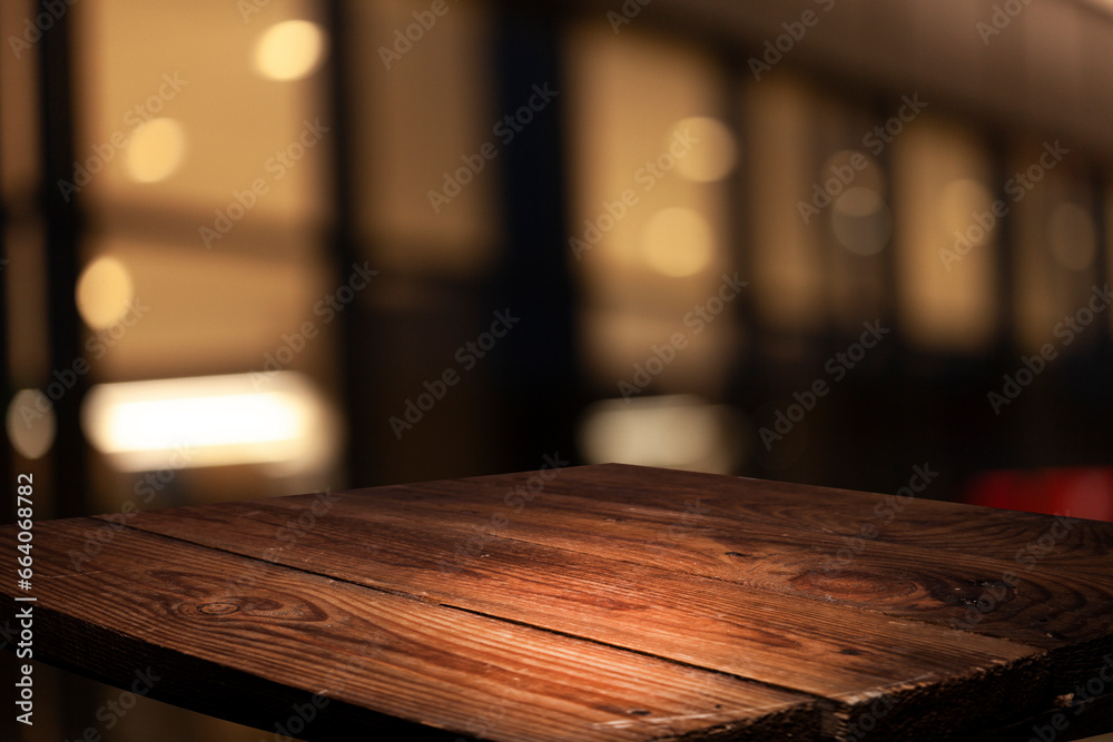Empty dark wooden table in front of abstract blurred bokeh background of restaurant, window frames. Can be used to display or mount your products. Mock for space.