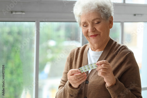 Elderly woman holding a bli...