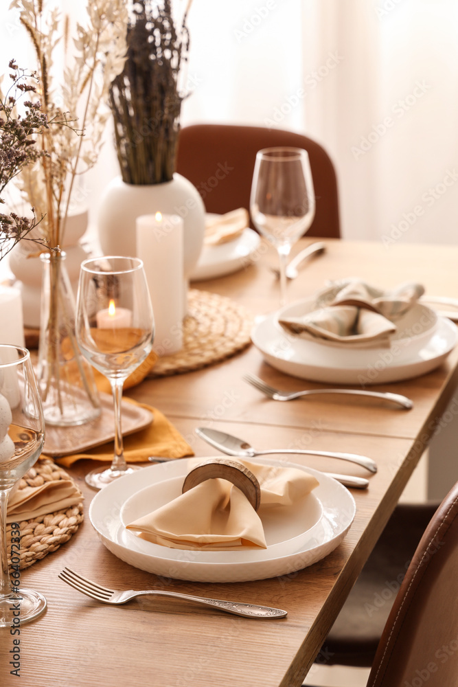 Elegant table setting with folded napkins, cutlery and plates