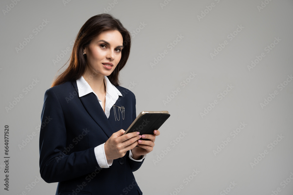 Portrait of successful woman chat manager working on touchpad. Smiling businesswoman in suit using digital tablet. Data analytics specialist browsing wireless computer Portrait of successful woman chat manager working on touchpad. Smiling businesswoman in suit using digital tablet. Data analytics specialist browsing wireless computer