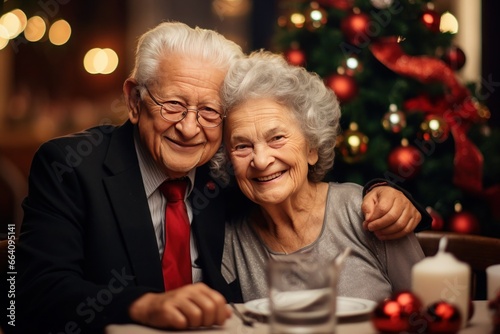  joyous elderly couple, both with silver hair, celebrate Christmas and New Year at the festive table