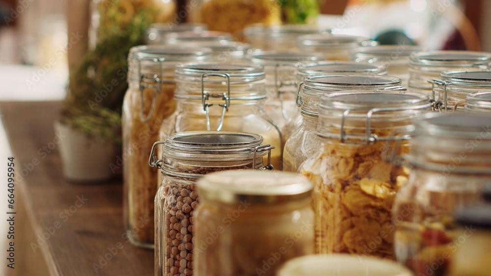 Close up on bulk products in recyclable glass containers used by zero waste supermarket to eliminate single use plastics. Local store pantry staples in sustainable packaging, zoom out shot Close up on bulk products in recyclable glass containers used by zero waste supermarket to eliminate single use plastics. Local store pantry staples in sustainable packaging, zoom out shot
