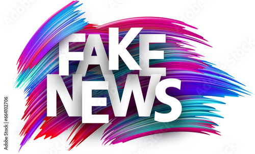 Fake news paper word sign with colorful spectrum paint brush strokes over white.