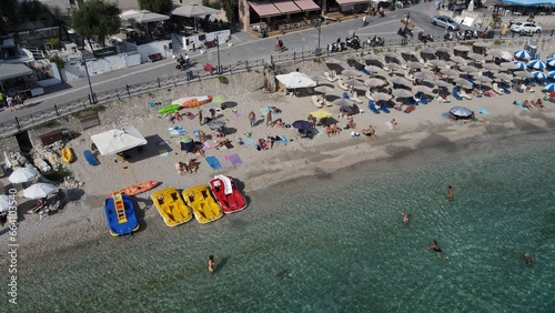 Aerial drone view parga greece, beach crowded with tourists in vacation on summer in famous greek caribbean parga town epirus preveza photo