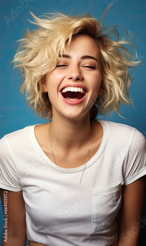 Portrait, a beautiful young woman with blonde hair against blue background. Woman wearing white T-shirt. T-shirt mock up.