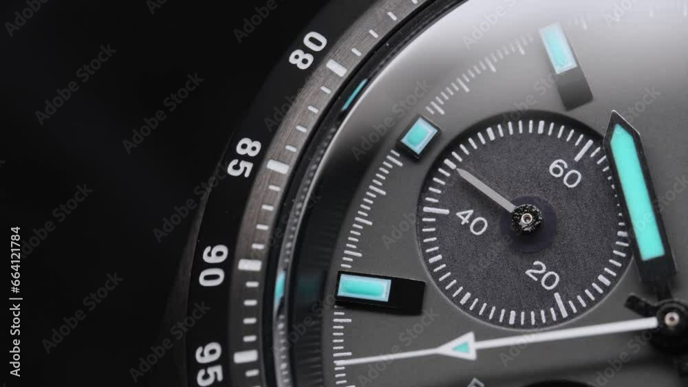 Second arrow running on the black clockface of luxury swiss watch with chronograph. Light flash on the turning clockface. Closeup real time shot. Running second arrow Second arrow running on the black clockface of luxury swiss watch with chronograph. Light flash on the turning clockface. Closeup real time shot. Running second arrow