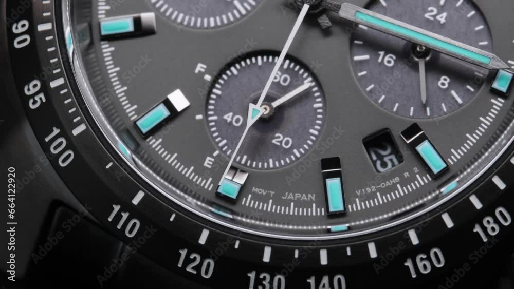 Second arrow running on the black clockface of luxury swiss watch with chronograph. Light flash on the turning clockface. Closeup real time shot. Running second arrow Second arrow running on the black clockface of luxury swiss watch with chronograph. Light flash on the turning clockface. Closeup real time shot. Running second arrow
