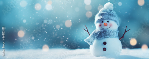 snowman on snow with copy space and bokeh blue background, Christmas snow background © Elena
