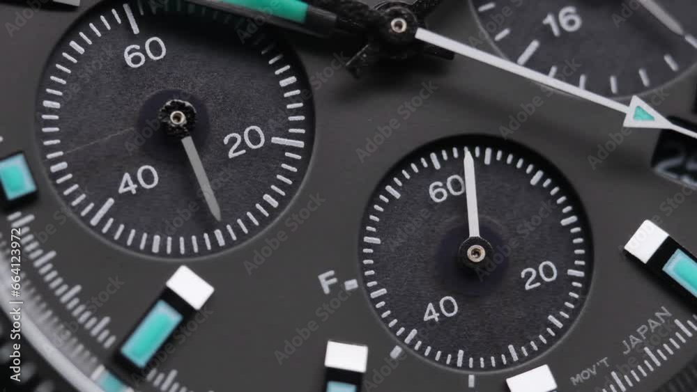 Second arrow running on the black clockface of luxury swiss watch with chronograph. Light flash on the turning clockface. Closeup real time shot. Running second arrow Second arrow running on the black clockface of luxury swiss watch with chronograph. Light flash on the turning clockface. Closeup real time shot. Running second arrow