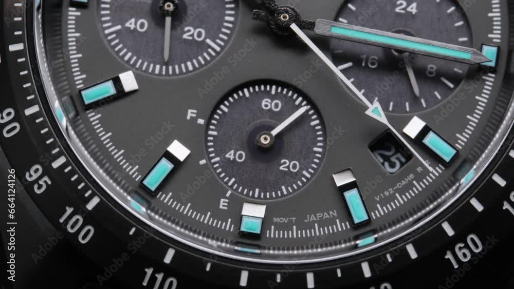 Second arrow running on the black clockface of luxury swiss watch with chronograph. Light flash on the turning clockface. Closeup real time shot. Running second arrow Second arrow running on the black clockface of luxury swiss watch with chronograph. Light flash on the turning clockface. Closeup real time shot. Running second arrow