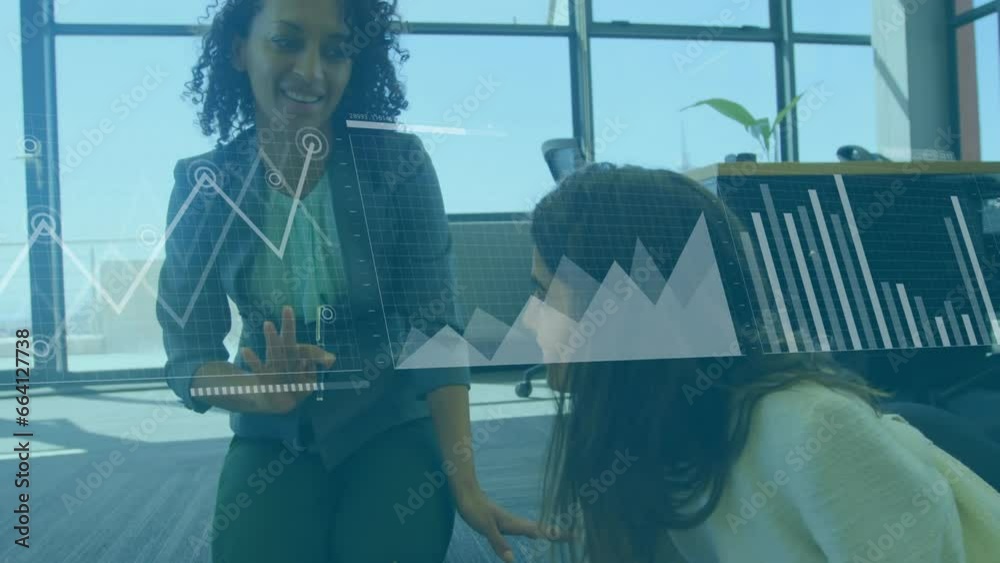 Animation of graphs, loading bars and map over diverse female coworkers discussing on desk Animation of graphs, loading bars and map over diverse female coworkers discussing on desk