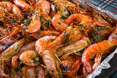 Dish of Mediterranean cuisine – baked in oven tiger shrimps with herbs