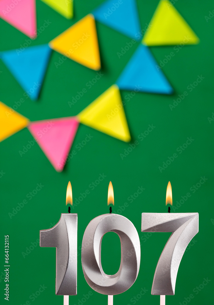 Vertical birthday card with number 107 candle - Green background with pennants Vertical birthday card with number 107 candle - Green background with pennants