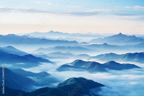 Mountain range covered in mist at dawn. Generative AI © Thalia