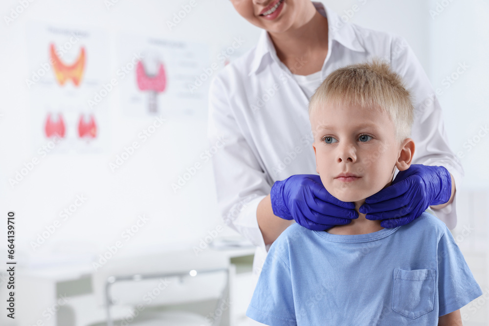 Endocrinologist examining boy's thyroid gland at hospital, closeup. Space for text Endocrinologist examining boy's thyroid gland at hospital, closeup. Space for text