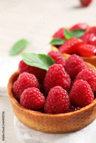 Tartlet with fresh raspberries on table, closeup and space for text. Delicious dessert