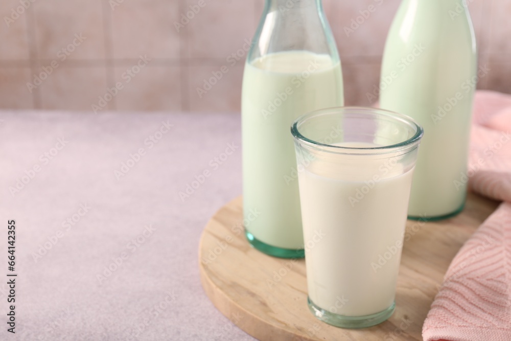 Glassware with tasty milk on table, closeup. Space for text Glassware with tasty milk on table, closeup. Space for text