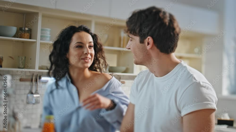 Joyful spouses cooking together at kitchen close up. Woman taking fresh juice. Joyful spouses cooking together at kitchen close up. Woman taking fresh juice.