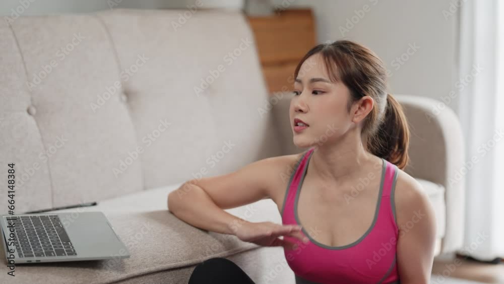 Asian woman sport trainer coach teaching on online social media at her home. Asian woman sport trainer coach teaching on online social media at her home.
