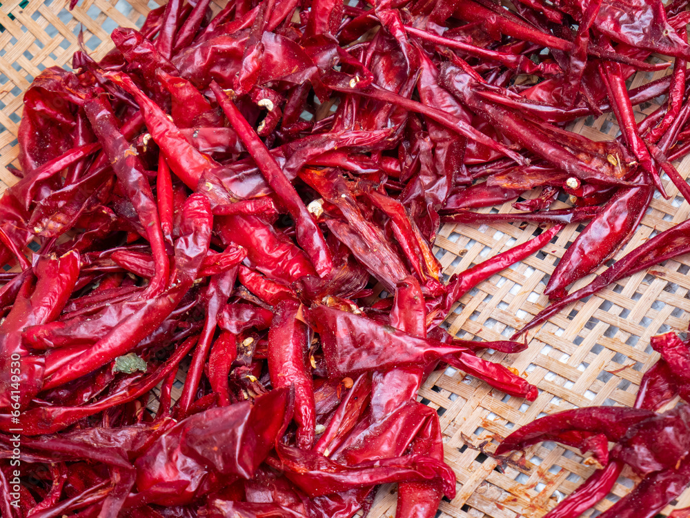 Dried red chilies on a winnowing pan
