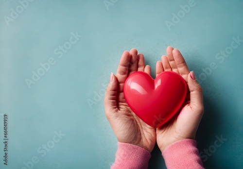 Red heart in hands on a blue background
