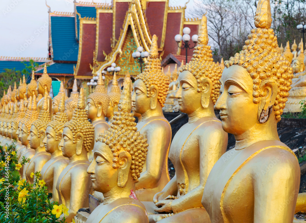 Fototapeta premium Many small,golden Buddha statues at Wat Phousalao,hilltop temple,reflecting sunset light,overlooking Mekong River,Pakse,southern Laos.