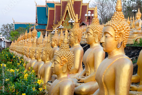 Many small,golden Buddha statues at Wat Phousalao,hilltop temple,reflecting sunset light,overlooking Mekong River,Pakse,southern Laos. photo