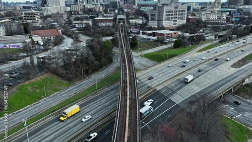 Hyperlapse shot of traffic on highway and crossing train on bridge in Atlanta