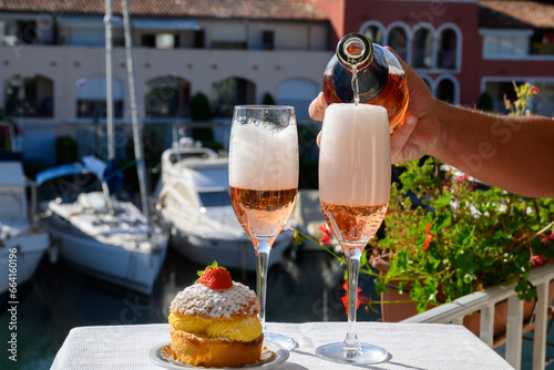 Summer party, drinking of French brut rose champagne sparkling wine in glasses in yacht harbour of Port Grimaud near Saint-Tropez, French Riviera vacation, France © barmalini