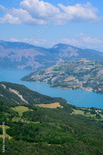 Aerial view on blue Lake of Serre-Poncon  reservoir  border between  Hautes-Alpes  and  Alpes-de-Haute Provence    departments  one of largest in  Western Europe
