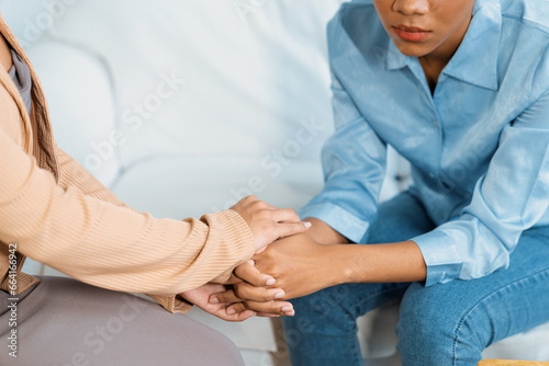 Close up shot of supportive and comforting hands for cheering up depressed patient person or stressed mind with crucial empathy