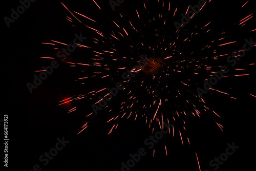 speckle of red explosion from fireworks