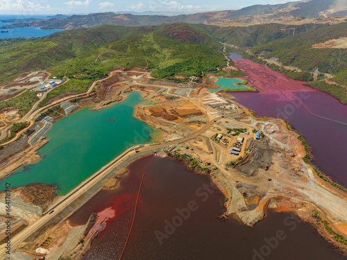 Birds eye of turquoise and maroon water lake in nickel mine. Mindanao, Philippines.