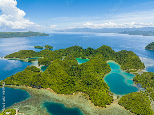 Tropical landscape of islands with lagoons. Turquoise water and deep blue sea under skyline. Mindanao, Philippines.