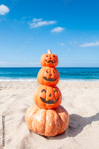 Four pumpkins on the beach - Halloween background