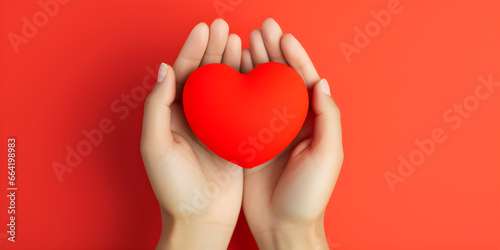 hands holding red heart isolated on red background with copy space