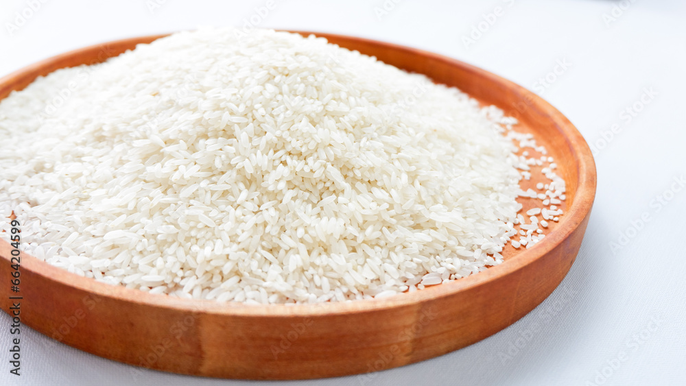 photo of white rice on wooden tray, isolated on white background. photo of white rice on wooden tray, isolated on white background.