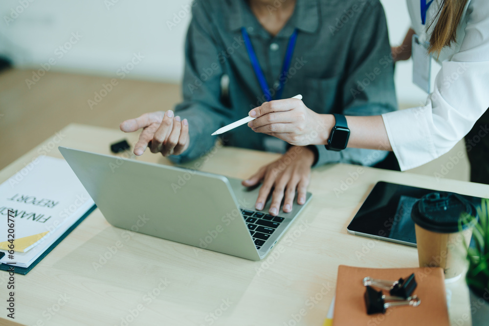 Two business men meeting to talking or discuss marketing work in workplace using paperwork, calculator, computer to work. Two business men meeting to talking or discuss marketing work in workplace using paperwork, calculator, computer to work.