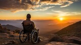 Amidst the grandeur of mountains at sunset, a disabled man in a wheelchair gazes into the horizon, embodying resilience and hope