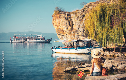 Macedonia- travel, tour tourism,vacation- Woman tourist enjoying Ohrid lake and famous traditional boats
