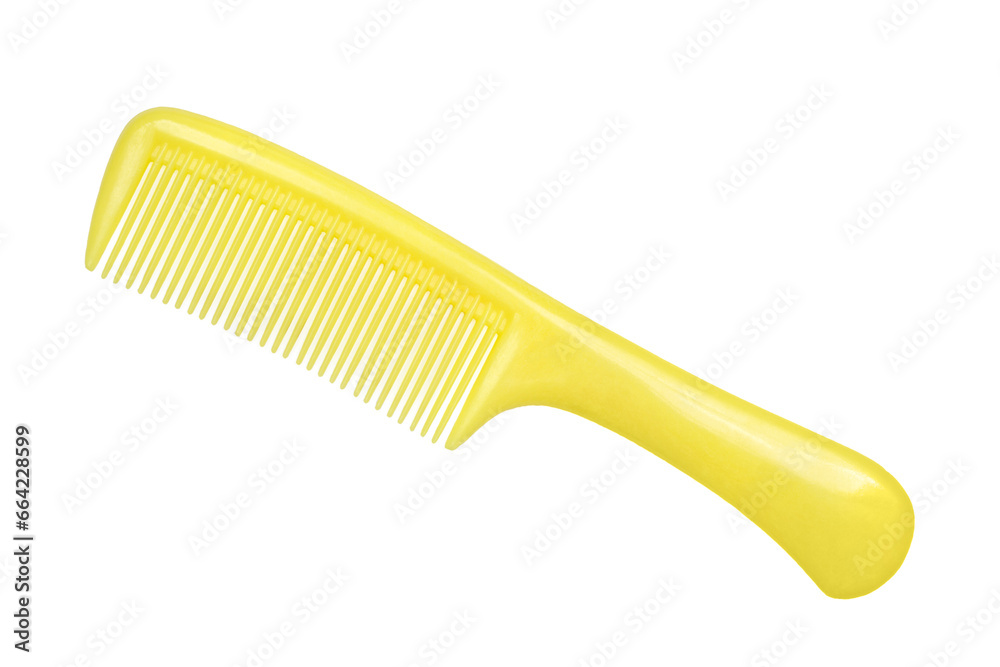 Yellow plastic comb on a white background. Comb close-up. Yellow plastic comb on a white background. Comb close-up.
