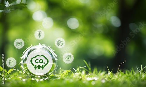 Reduction of carbon emissions, carbon neutral concept. Net zero greenhouse gas emissions target. Reducing carbon footprint concept. Decreasing CO2 emissions target symbol on green view background. photo
