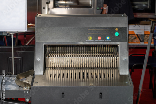 Industrial bread slicing machine for slicing bread into thin symmetrical slices.