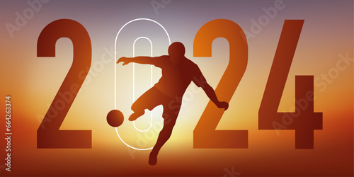 Concept du sport sur le thème du football pour une carte de vœux 2024, montrant un footballeur qui frappe le ballon du pied pour marquer un but. photo