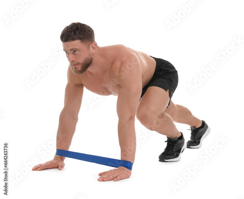 Young man exercising with elastic resistance band on white background